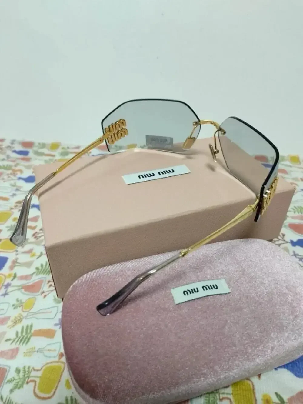 Miu Miu Rimless Grey Sunglasses with Oversized Gold Logo